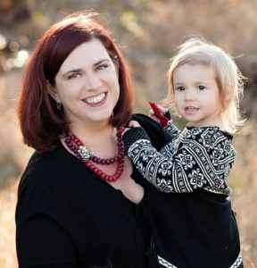 smiling woman holding young child