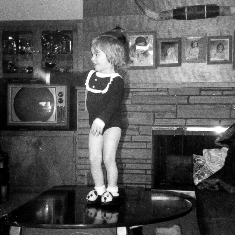 little girl tap-dancing on coffee table