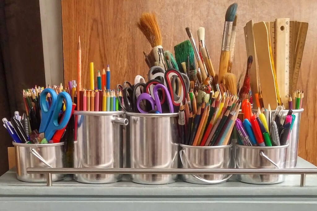 art supplies in silver buckets