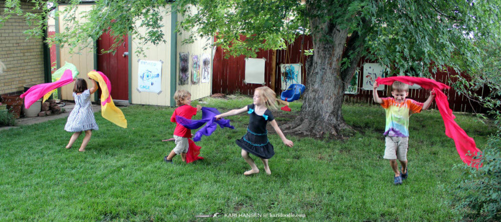 kids dancing with coloful scarves