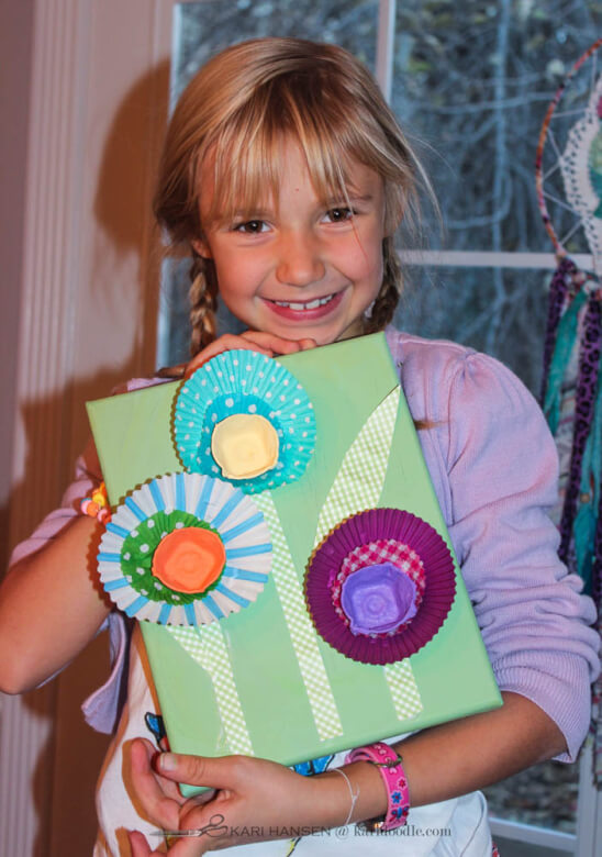 girl proudly showing collage