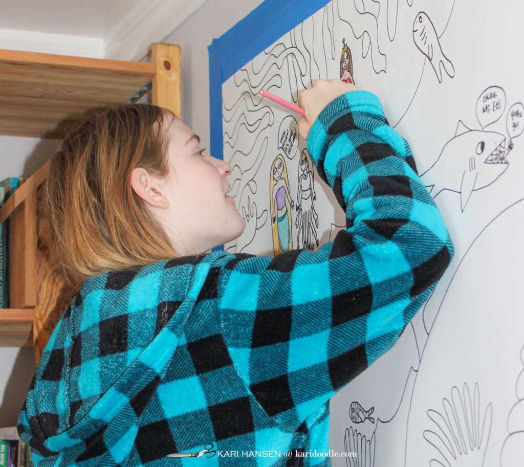 girl coloring hand-drawn paper mural