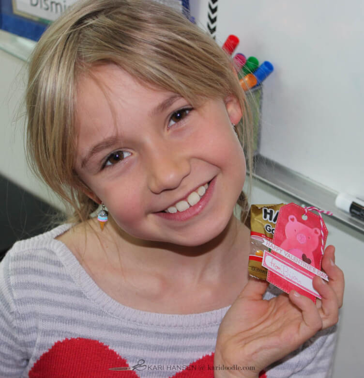 smiling girl holding handmade gummy bear valentines