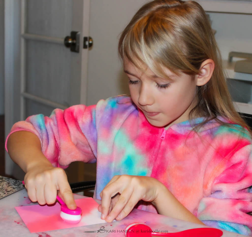 girl blending pink inks on paper