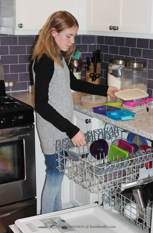 girl emptying dish washer