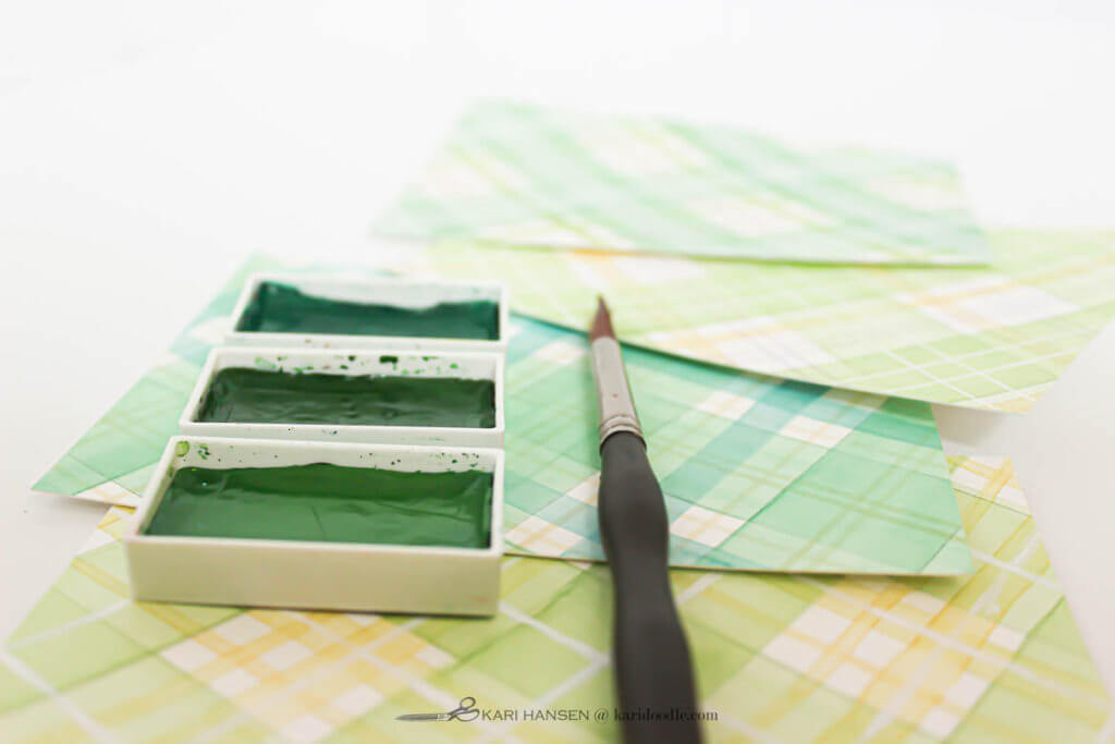 green watercolor tartan panels with paint pans and brush