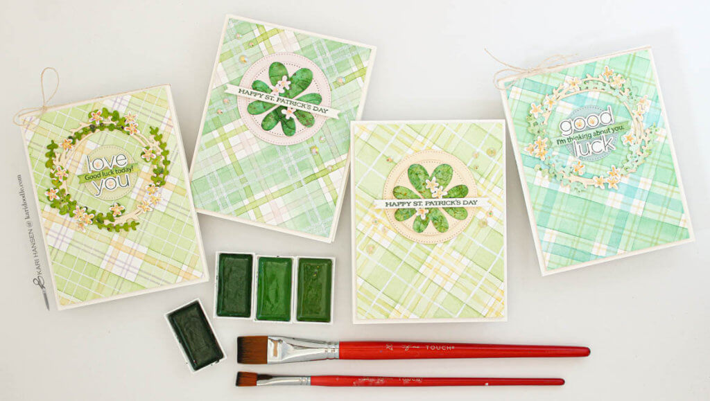 4 green watercolor tartan cards with paint and brushes